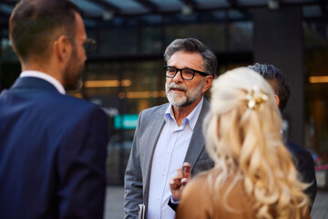 Colleagues converse outside