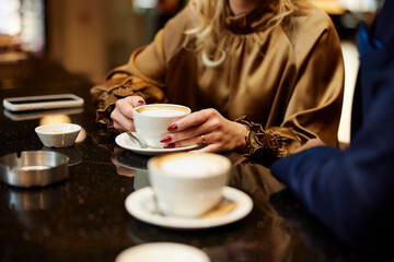 People drink coffee together
