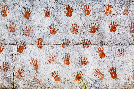 India, Gujarat. White plaster walls with hand prints. Good luck symbol.