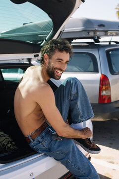 A young surfer changing clothes 