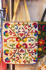Sokalipura, Srinagar, Jammu and Kashmir, India. Embroidered handbag for sale at a market.