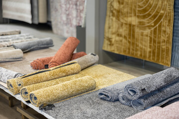 Shop window presents several carpet options, different sizes and colors. You can buy variety of carpets in home goods department.