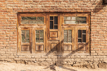 Wangath, Kangan, Jammu and Kashmir, India. Wooden window in a brick house in a village.