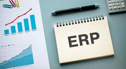 There is notebook with the word ERP. It is an abbreviation for Enterprise Resources Planning as eye-catching image.