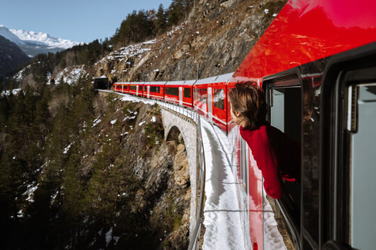 Woman looking out of window of Bernina express train