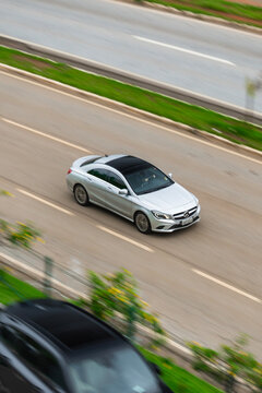 Silver Mercedes-Benz CLA with a panoramic roof - Panning shot of a luxury sedan
