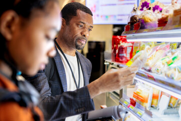 Man buying food product from supermarket