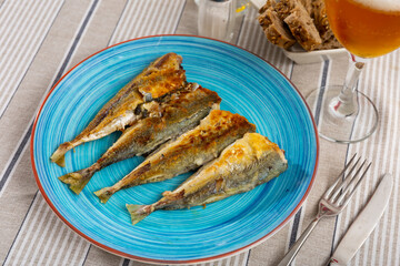 Delicious serving of grilled horse mackerel with beer and bread