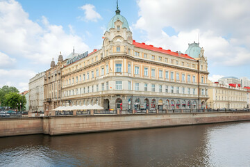 Historic Building Stands Majestically Beside a Calm River Under a Cloudy Sky
