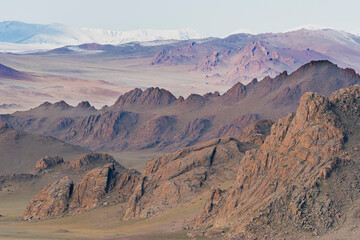 Naklejka premium Asia, Mongolia, Bayan-Olgii Province, Altai Mountains. Scenic view of the rugged mountains with grasslands in the foreground.