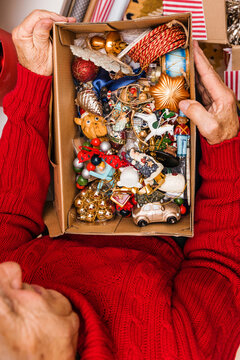 A man pulls Christmas toys out of a box 
