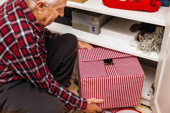 A man pulls out a box of Christmas decorations 