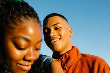 black man shares a joyful moment with his curvy friend in a park