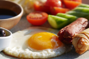 Delicious Breakfast Plate with Egg, Sausage, and Fresh Vegetables
