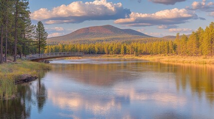 Fototapeta premium Serene Autumn River Landscape with Bridge and Mountain