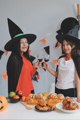 Fototapeta premium friendship, holiday and people concept - group of happy smiling friends in halloween costumes of vampire, devil, witch and cheetah at home party