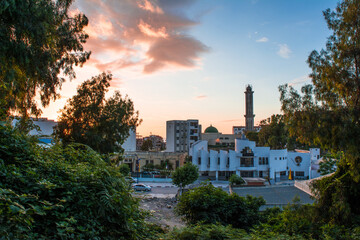 Muslim mosque for prayer and worship of Allah, Omar bin Abdul Aziz Mosque, Jijel State, Algeria, North African mosques in village on Mediterranean coast, Minaret and dome of  mosque, Ramadan iftar.