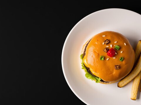 A chessburger, complete with a toasted bun, juicy patty, melted cheese, fresh lettuce, and red tomato, sits on a white plate on a sleek black background, tasty, indulgent, savory