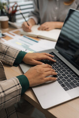 a businesswoman is using an electronic device to search and send information to her team, the marketing team leader is reviewing documents related to marketing data