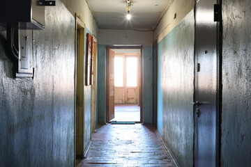 An Empty Corridor Featuring an Open Door and Bathed in Natural Light from Outside