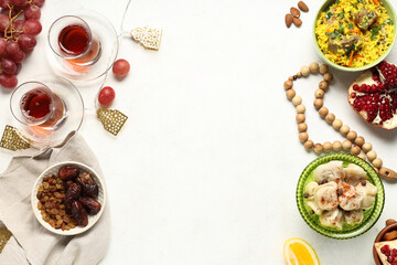 Traditional Eastern dishes and prayer beads on white table. Ramadan celebration