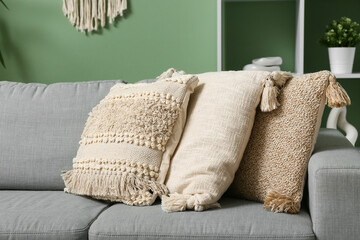 Grey sofa with soft cushions in stylish living room