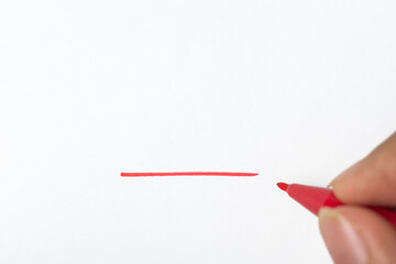 close up of hand making red underline with marker isolated on white background