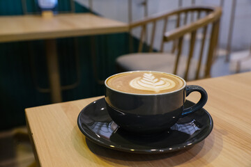 A cup of hot latte coffee on the table for breakfast
