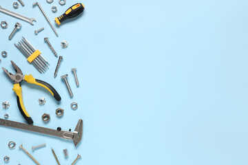 Tap bolts, chrome nuts and tools on blue background