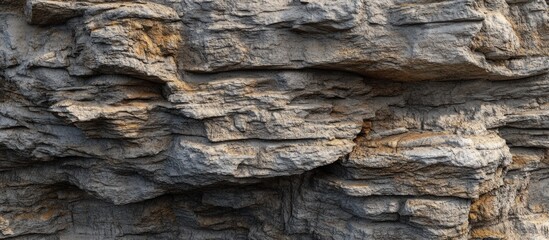 Rough, grey and brown stone wall texture.