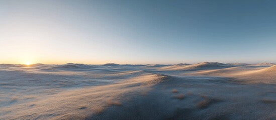 Serene sunrise over a vast, sandy desert landscape.