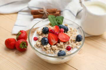 Composition with tasty oatmeal and berries on wooden background