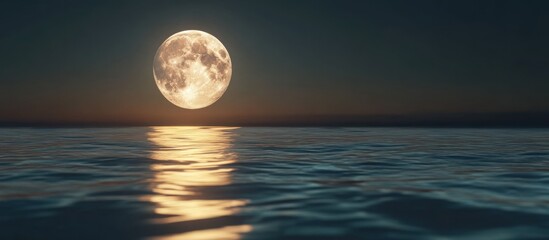 Full moon rising over calm ocean at night.