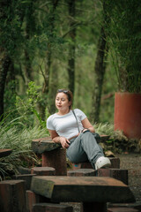 Happy Woman in Casual Outfit Enjoying a Peaceful Forest Setting Outdoors