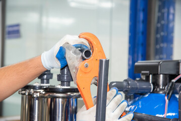Water pipe man measuring water pipes cutting water pipes for industrial RO water filtration systems, hospitals, schools, factories