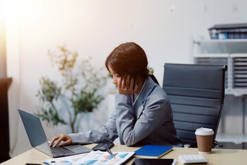 Asian women are stressed while working on laptop, Tired asian businesswoman with headache at...