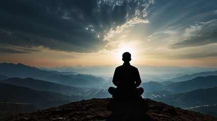 silhouette of person meditating on the mountain