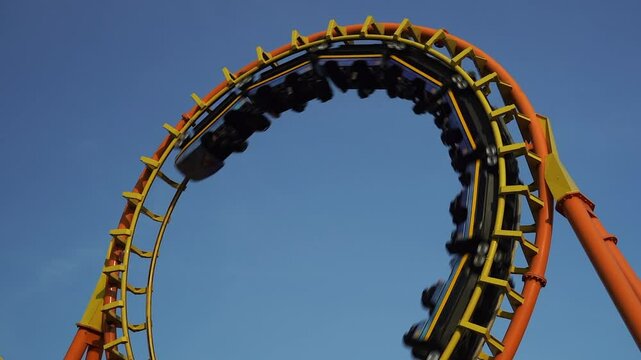 Roller coaster Ride against Roller coaster in the amusement park.