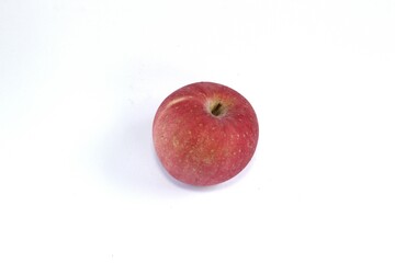 A Fuji apple, or Malus pumila, or Malus domestica on a white background. This apple has a yellowish-red skin color and a sweet honey flavor.