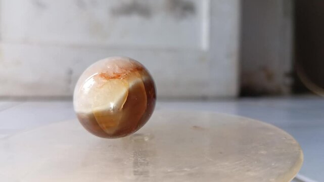 Souvenirs made of beautiful stone with a egg shape are rotated in a display case