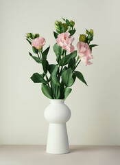 Eustoma bouquet in a white minimalist ceramic vase in Scandinavian style