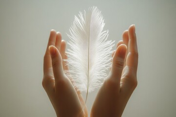 Hands gently holding a white feather symbolizing delicacy and purity