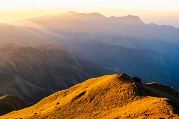 Golden mountain ridge with sunrise rays