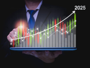 Business goals trends 2025 businessman showing virtual hologram stocks growing on hand