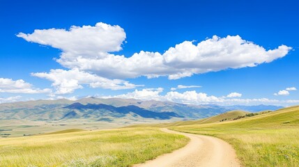 Fototapeta premium Winding Dirt Road Through Sunny Mountain Valley