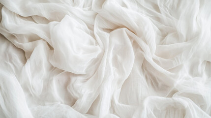Fototapeta premium Soft white fabric draped gracefully over a surface creating an elegant texture