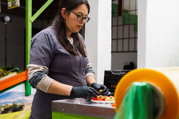 a young woman preparing strawberries on a tray for packaging at a fresh produce store.