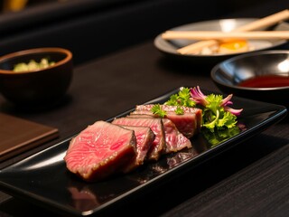 Japanese kobe beef slices arranged on a sleek ceramic plate set against a black background, dining, background