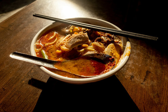 A bowl of prawn noodle soup or "hokkien mee" in Penang served with water spinach, slices of meat and little prawns