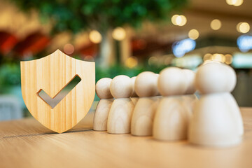 Shield icon and people model. Security protection and group  insurance. The concept of family home,...